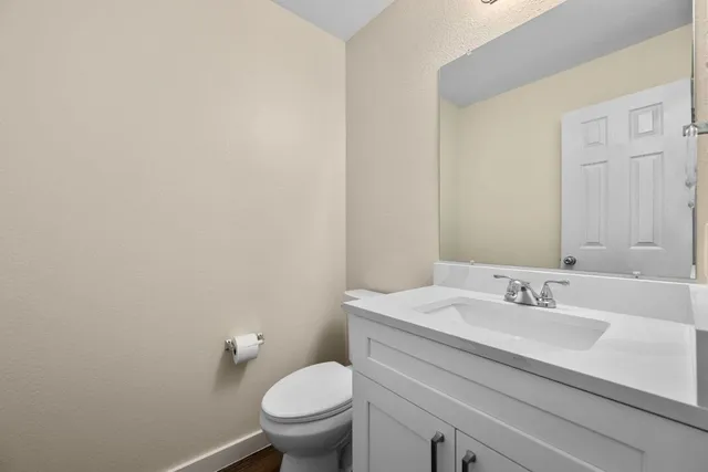 a bathroom with a sink toilet and a mirror