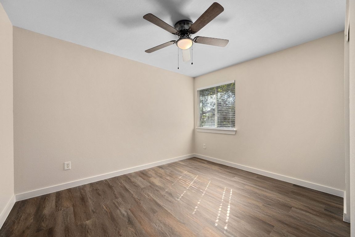 11116 Jim Thorpe Lane Austin, TX 78748 - Photo 18 of 31 an empty room with wooden floor and ceiling fan