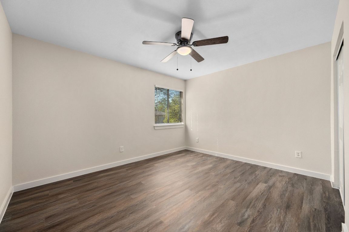 11116 Jim Thorpe Lane Austin, TX 78748 - Photo 19 of 31 an empty room with wooden floor ceiling fan and windows