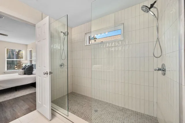 a bathroom with a glass shower door