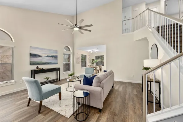 a dining room with furniture a floor to ceiling window and wooden floor