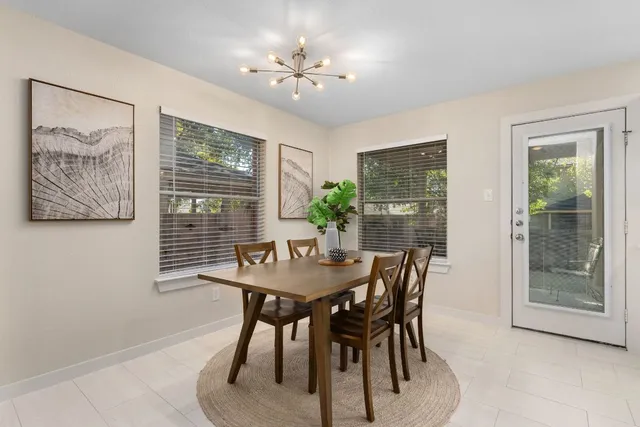 a view of a dining room with furniture and a chandelier
