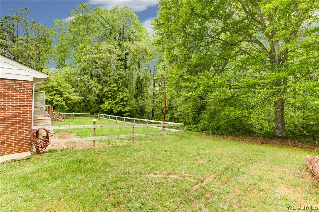 18506 Beaver Dam Road Beaverdam, VA 23015 - Photo 36 of 44 a view of a swimming pool with a yard and large trees