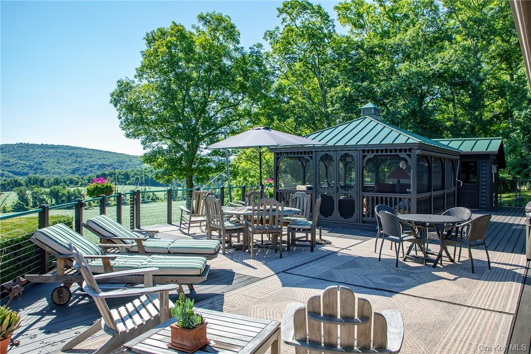 an outdoor space with patio furniture and wooden floor