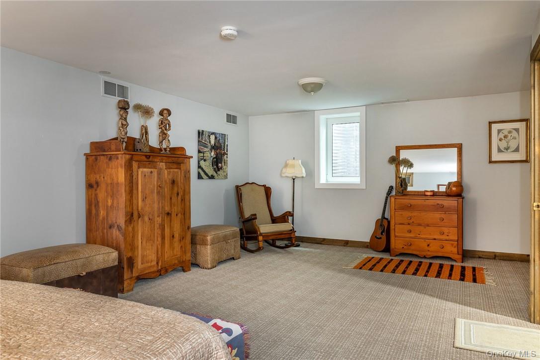 617 Bean River Road Pine Plains, NY 12546 - Photo 23 of 40 a bedroom with bed and mirror