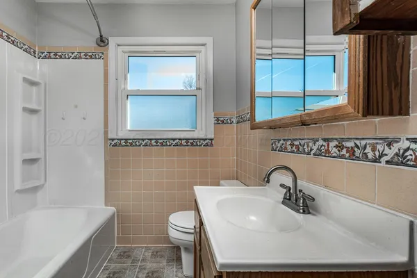 a bathroom with a sink a toilet and tub