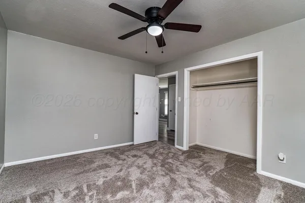 a view of a livingroom with a ceiling fan and a chandelier fan