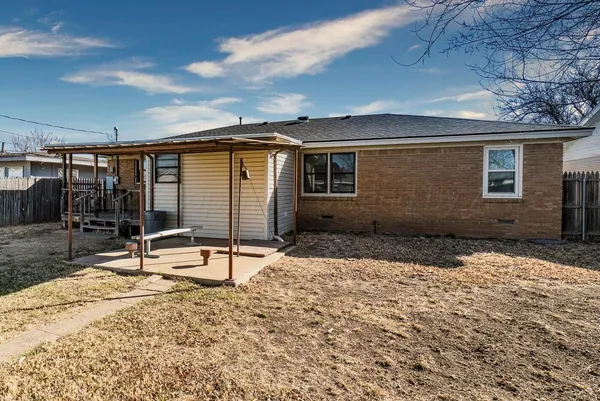 a backyard of a house with table and chairs
