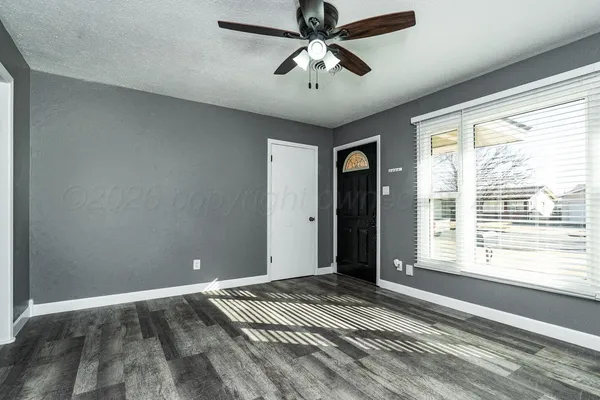 a view of an empty room with a window