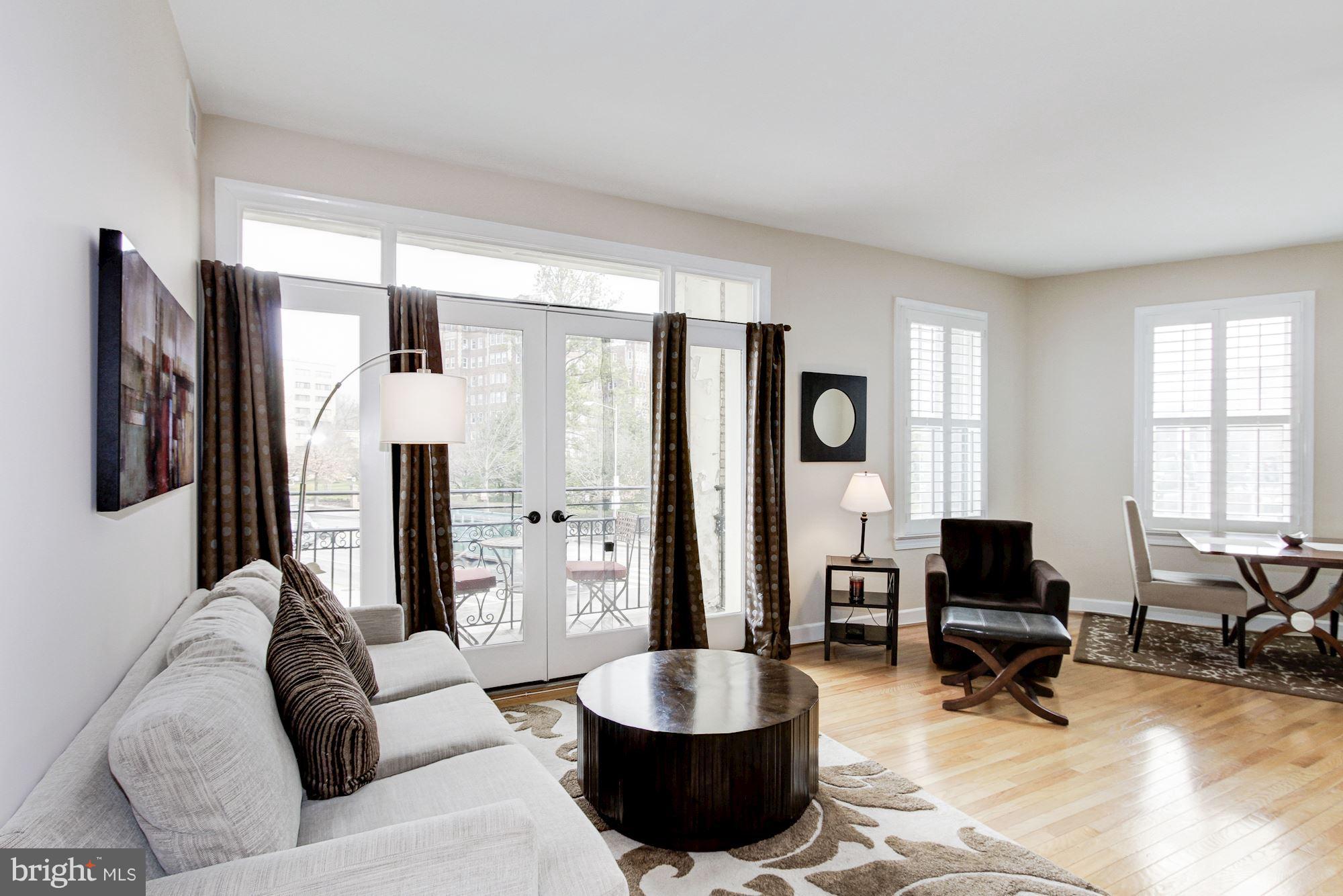2902 Porter Street Northwest, Unit 21 Washington, DC 20008 - Photo 1 of 18 a living room with furniture and a large mirror