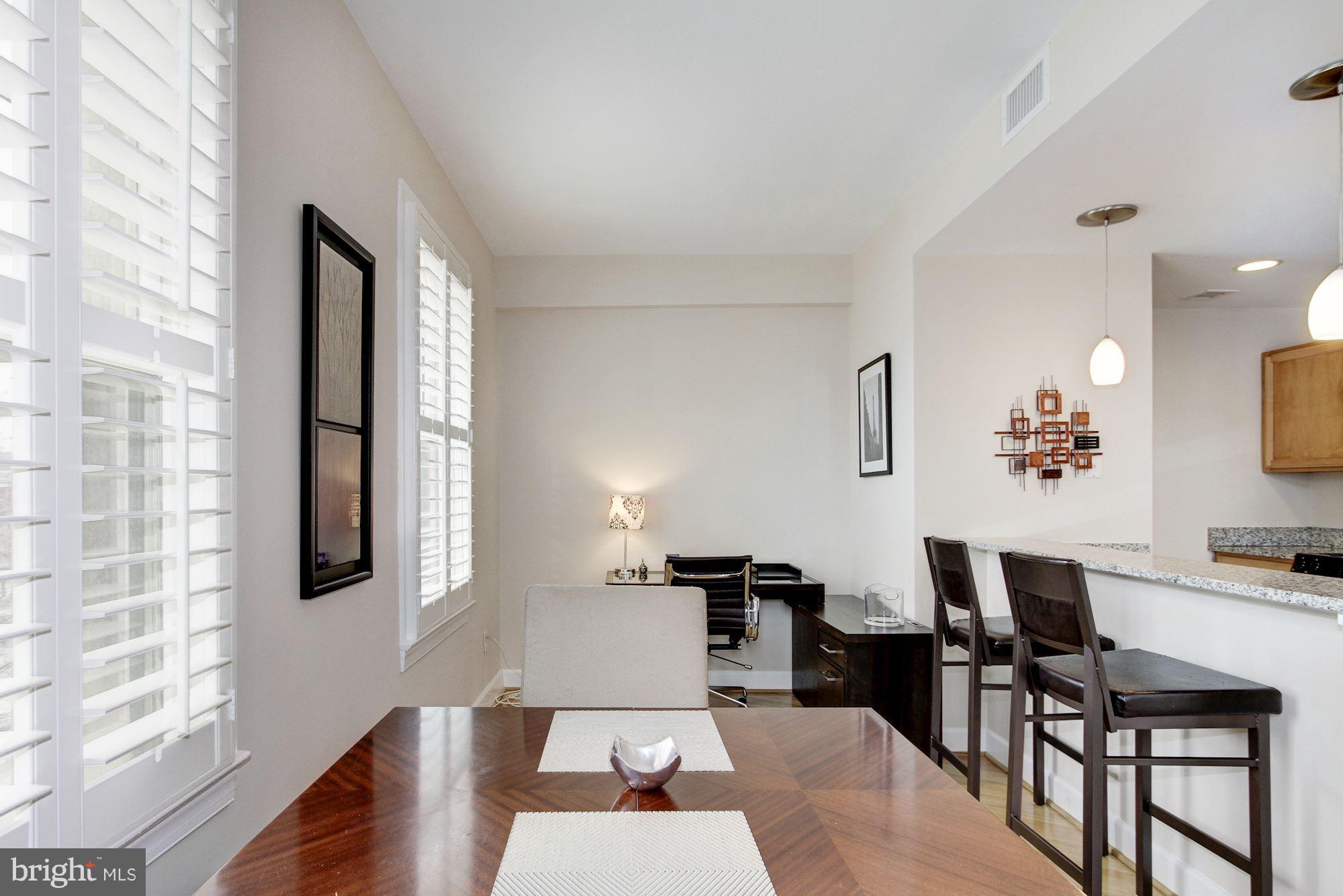 2902 Porter Street Northwest, Unit 21 Washington, DC 20008 - Photo 11 of 18 a living room with furniture and wooden floor