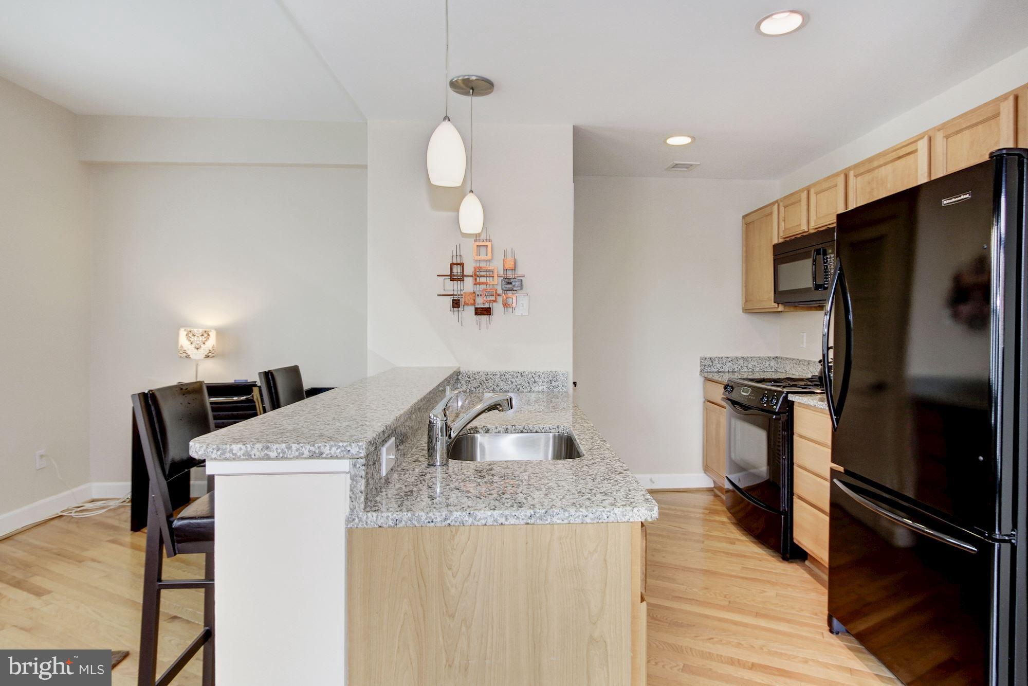 2902 Porter Street Northwest, Unit 21 Washington, DC 20008 - Photo 12 of 18 a kitchen with a sink a stove and refrigerator
