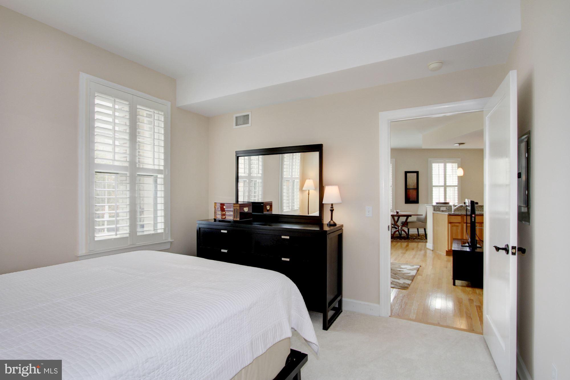2902 Porter Street Northwest, Unit 21 Washington, DC 20008 - Photo 15 of 18 a bedroom with a bed and a large mirror