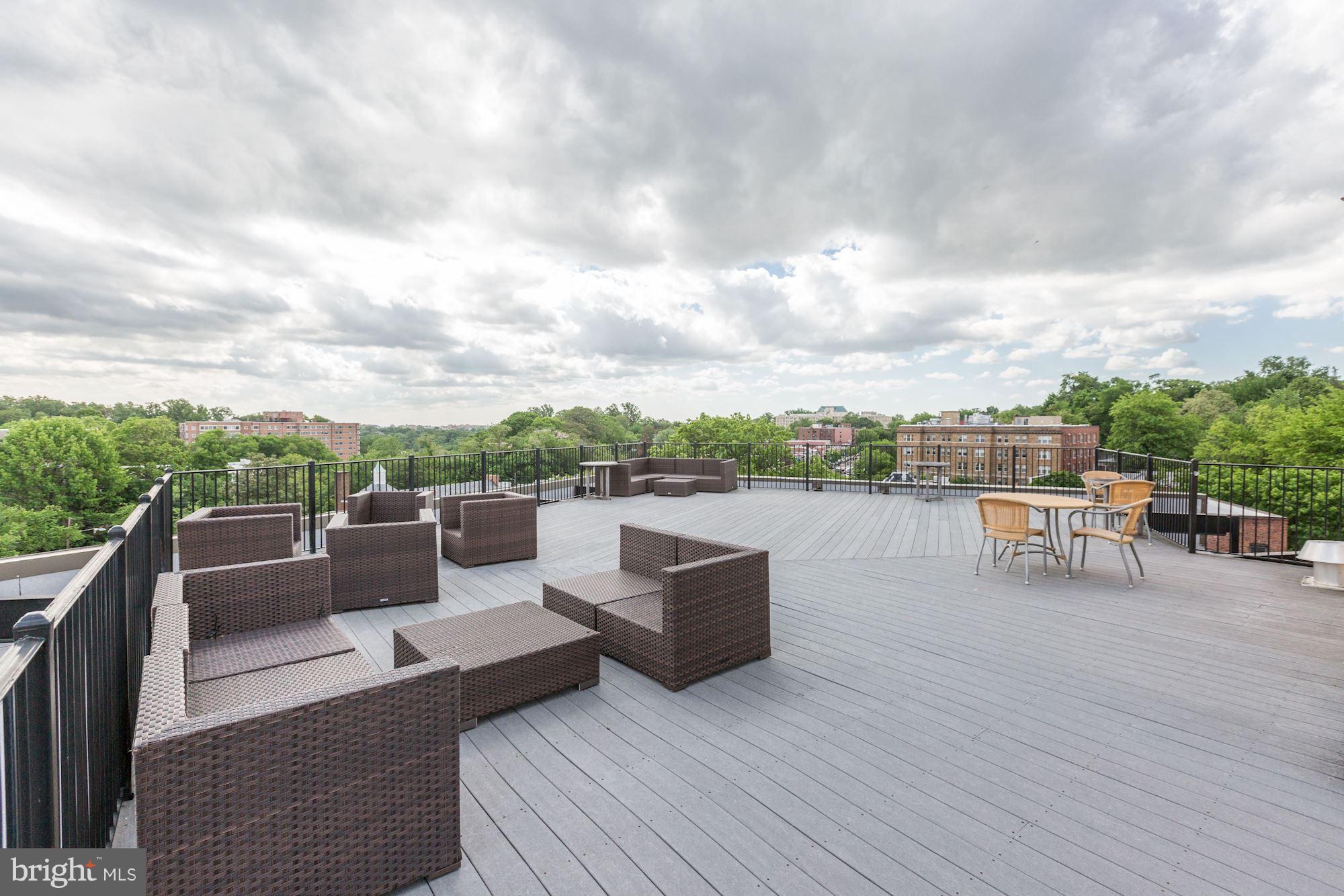 2902 Porter Street Northwest, Unit 21 Washington, DC 20008 - Photo 18 of 18 an outdoor sitting area with couch and wooden fence