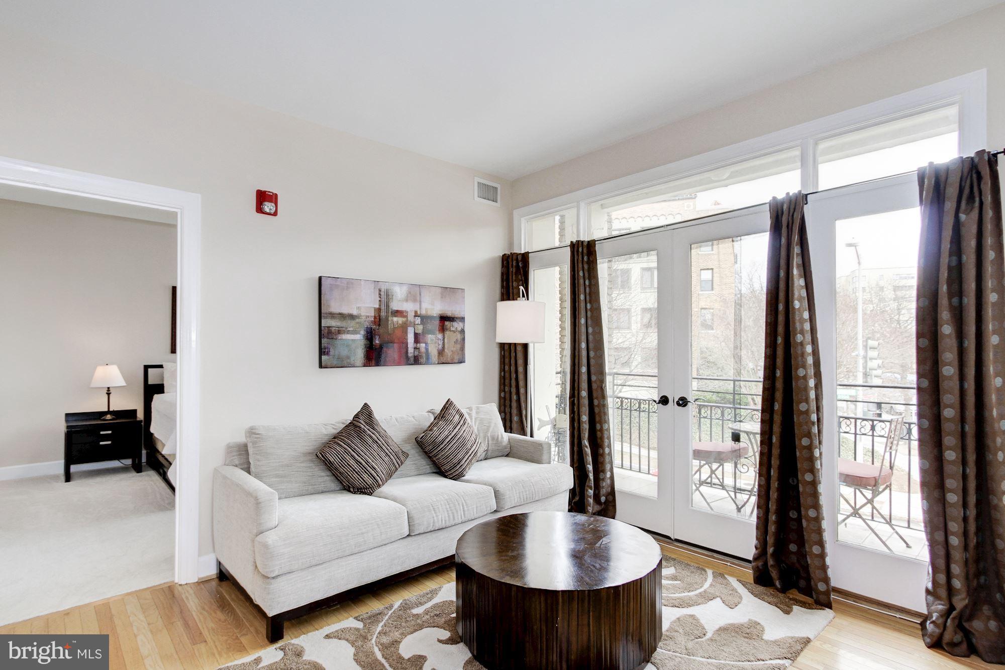 2902 Porter Street Northwest, Unit 21 Washington, DC 20008 - Photo 6 of 18 a living room with furniture and a large window