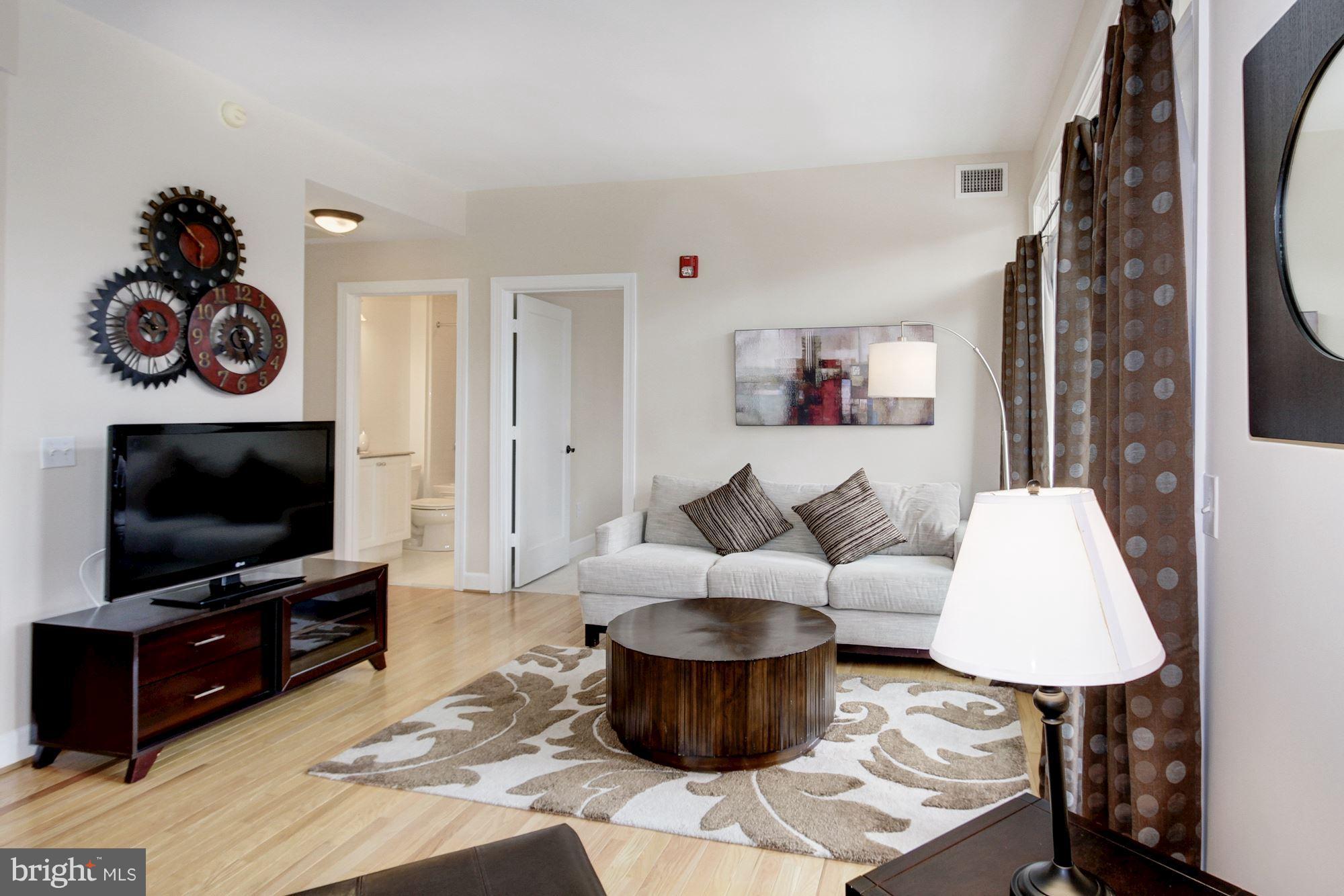 2902 Porter Street Northwest, Unit 21 Washington, DC 20008 - Photo 9 of 18 a living room with furniture and a flat screen tv