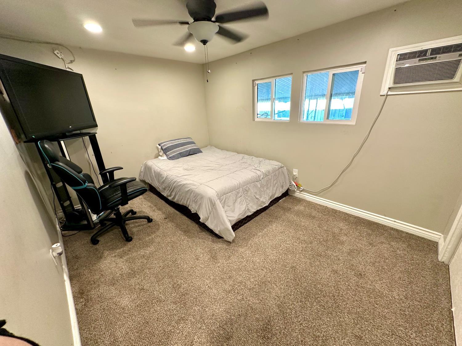 3435 Marfargoa Road, Unit 74 Stockton, CA 95215 - Photo 10 of 21 a bedroom with a bed and a flat screen tv