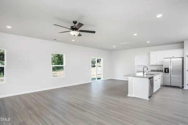 a view of a kitchen with a sink stainless steel appliances and cabinets