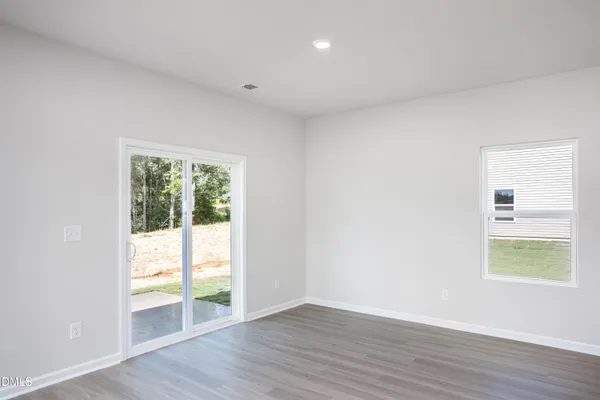 a kitchen with stainless steel appliances granite countertop a sink a stove a refrigerator and white cabinets