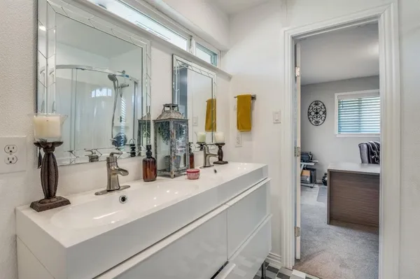 a bathroom with double vanity sink a mirror and a vanity