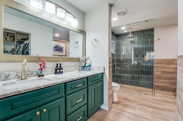 a bathroom with a sink double vanity and a shower