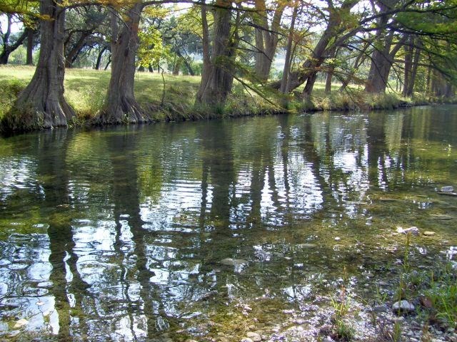 0 Frio Canyon Loop Concan, TX 78838 - Photo 14 of 14 a body of water with a tree in the background