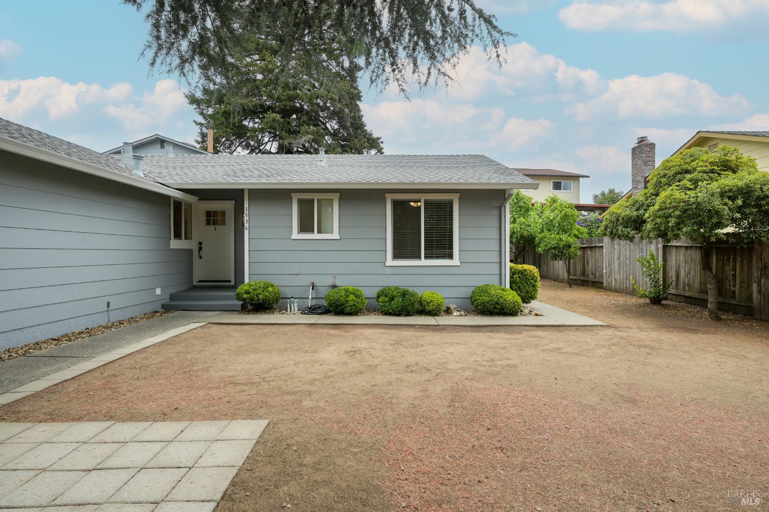 a front view of a house with a yard and a garage