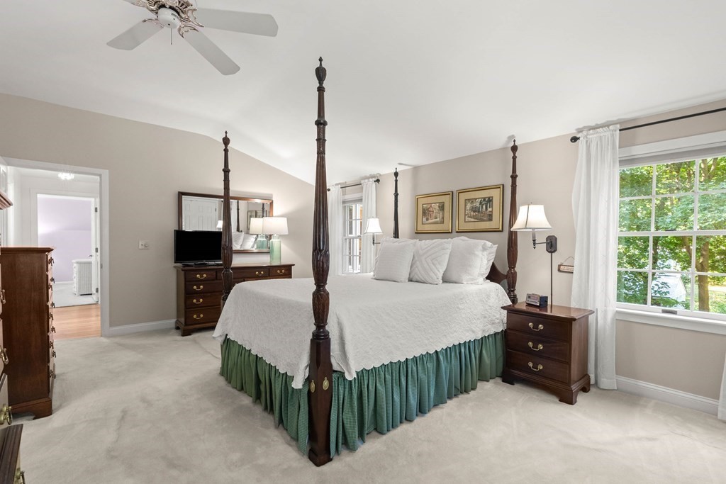 220 Perkins Row Topsfield, MA 01983 - Photo 22 of 42 a bed room with a bed and a chandelier