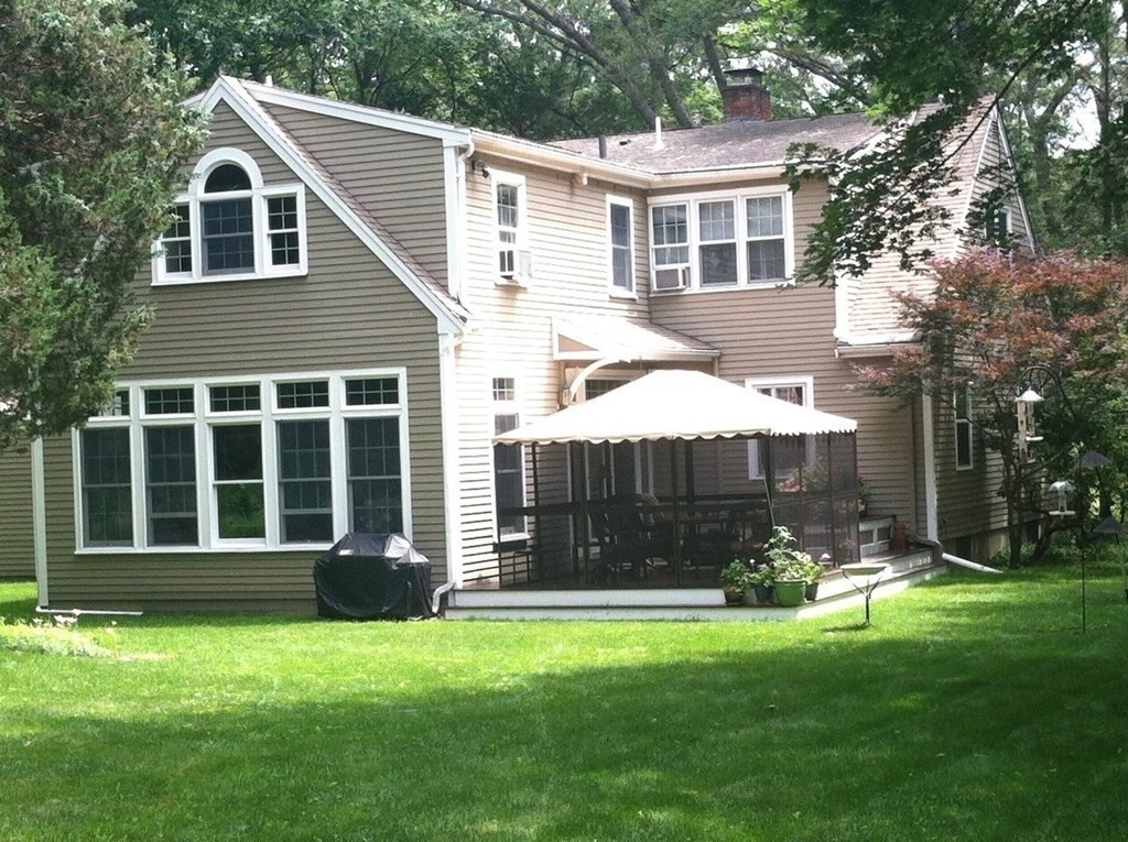220 Perkins Row Topsfield, MA 01983 - Photo 34 of 42 a front view of a house with a garden