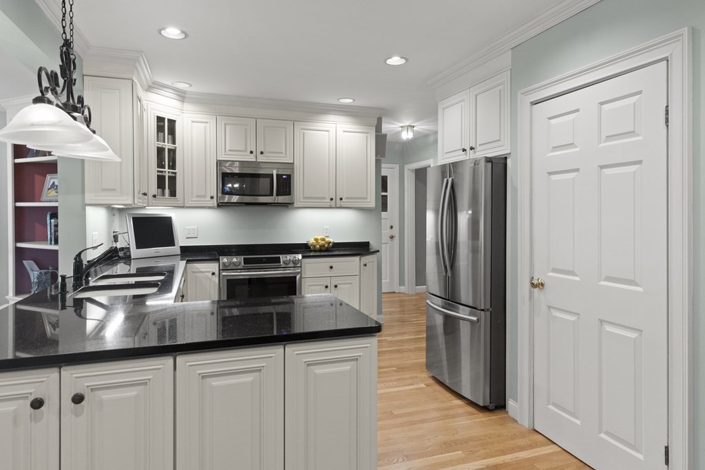 220 Perkins Row Topsfield, MA 01983 - Photo 8 of 42 a kitchen with stainless steel appliances granite countertop a refrigerator a stove a sink and a center island