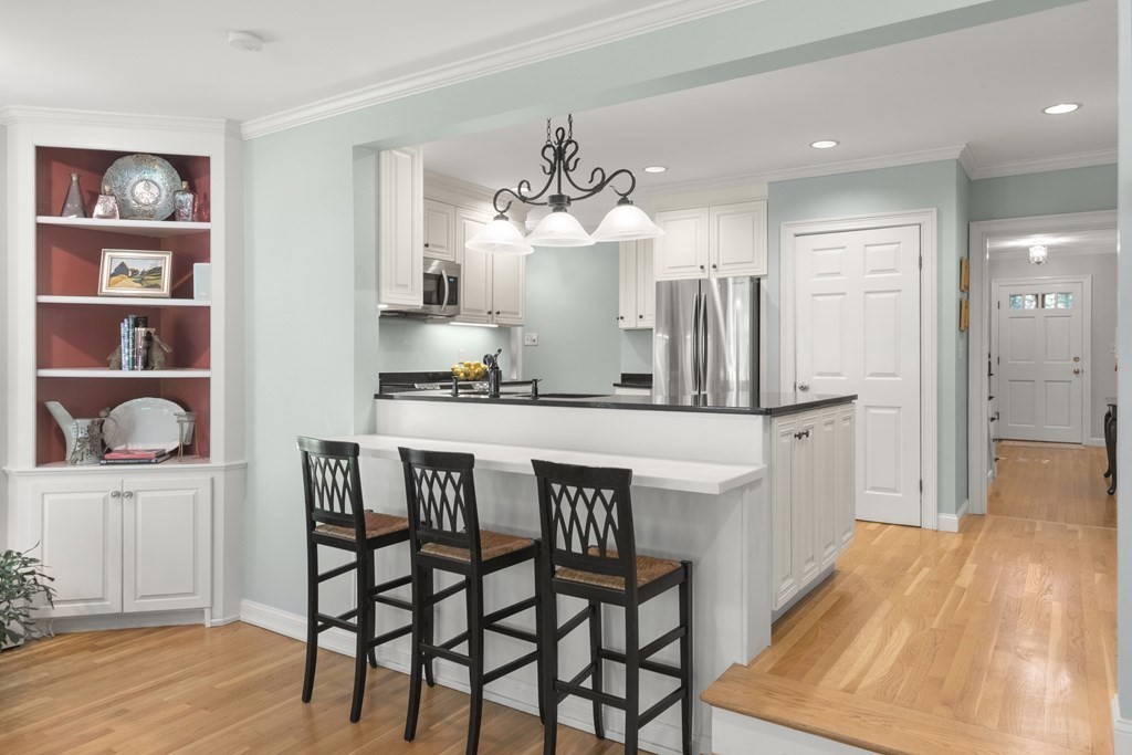 220 Perkins Row Topsfield, MA 01983 - Photo 9 of 42 a dining room with wooden floor and chandelier