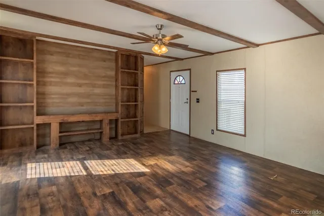 a view of a kitchen with wooden floor and a window