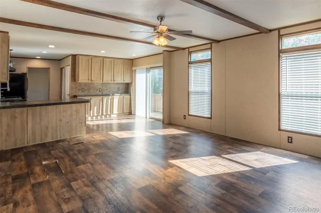 a kitchen with granite countertop a stove top oven and cabinets