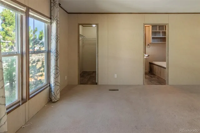 a bathroom with a granite countertop sink and a toilet