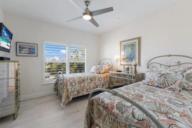 a bedroom with a bed and a painting on the wall