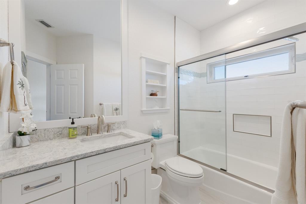 799 Beach View Drive Boca Grande, FL 33921 - Photo 16 of 77 a bathroom with a granite countertop sink toilet and shower