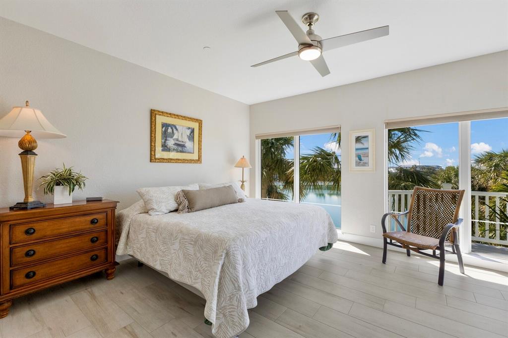 799 Beach View Drive Boca Grande, FL 33921 - Photo 17 of 77 a bedroom with a bed and a painting on the wall