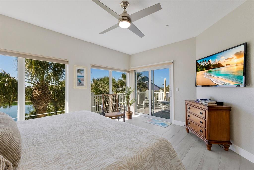 799 Beach View Drive Boca Grande, FL 33921 - Photo 18 of 77 a bedroom with a bed and a flat tv screen on dresser