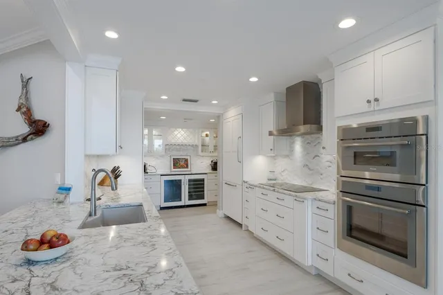 a large white kitchen with a large window