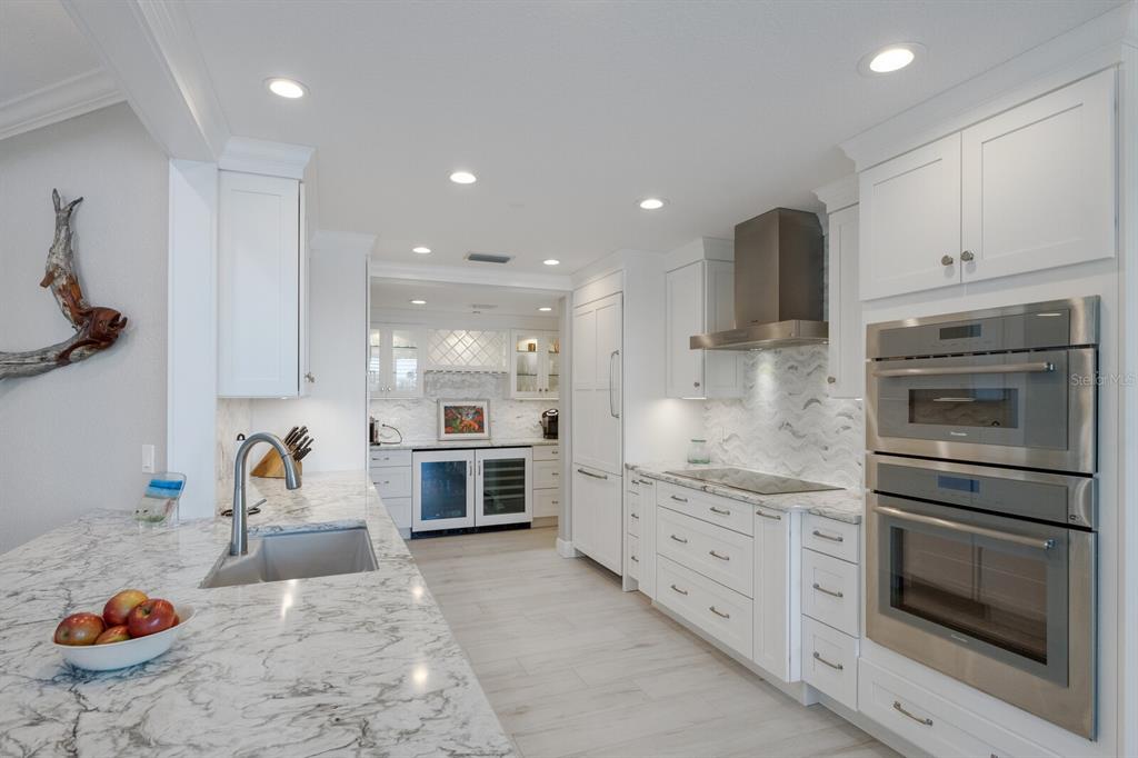 799 Beach View Drive Boca Grande, FL 33921 - Photo 8 of 77 a kitchen with stainless steel appliances kitchen island granite countertop a sink and cabinets