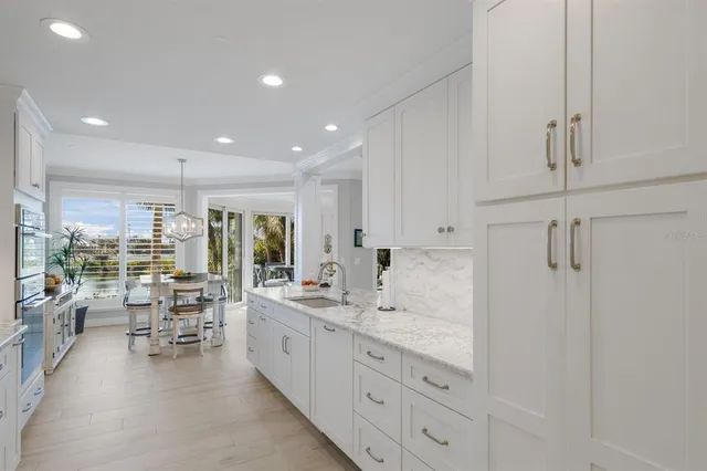a kitchen with granite countertop a sink and a stove