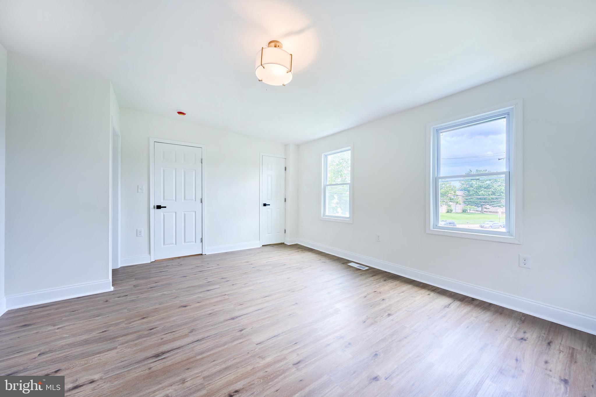 3511 Old Frederick Road Baltimore, MD 21229 - Photo 28 of 43 an empty room with wooden floor and windows