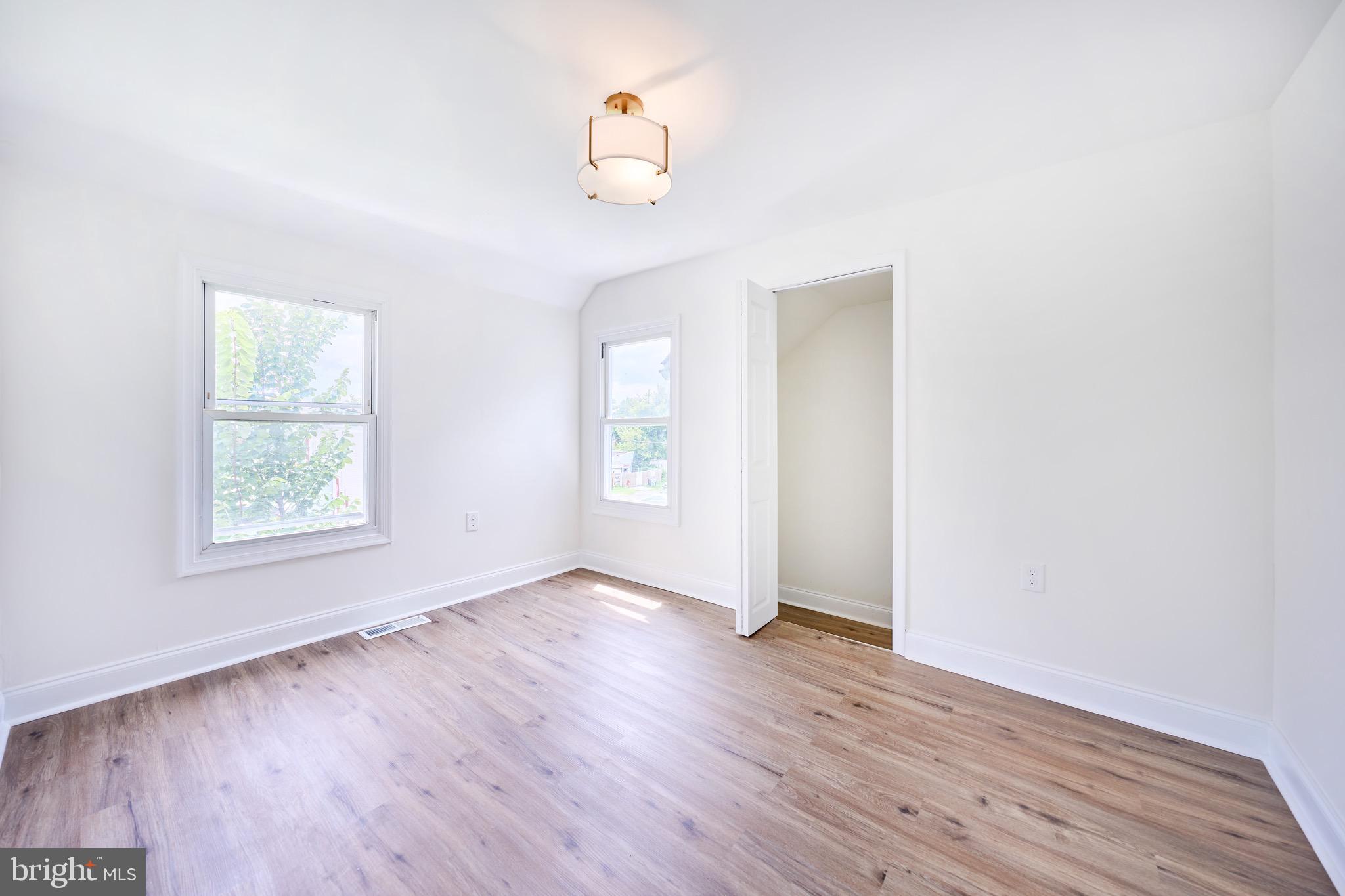 3511 Old Frederick Road Baltimore, MD 21229 - Photo 36 of 43 an empty room with wooden floor and windows