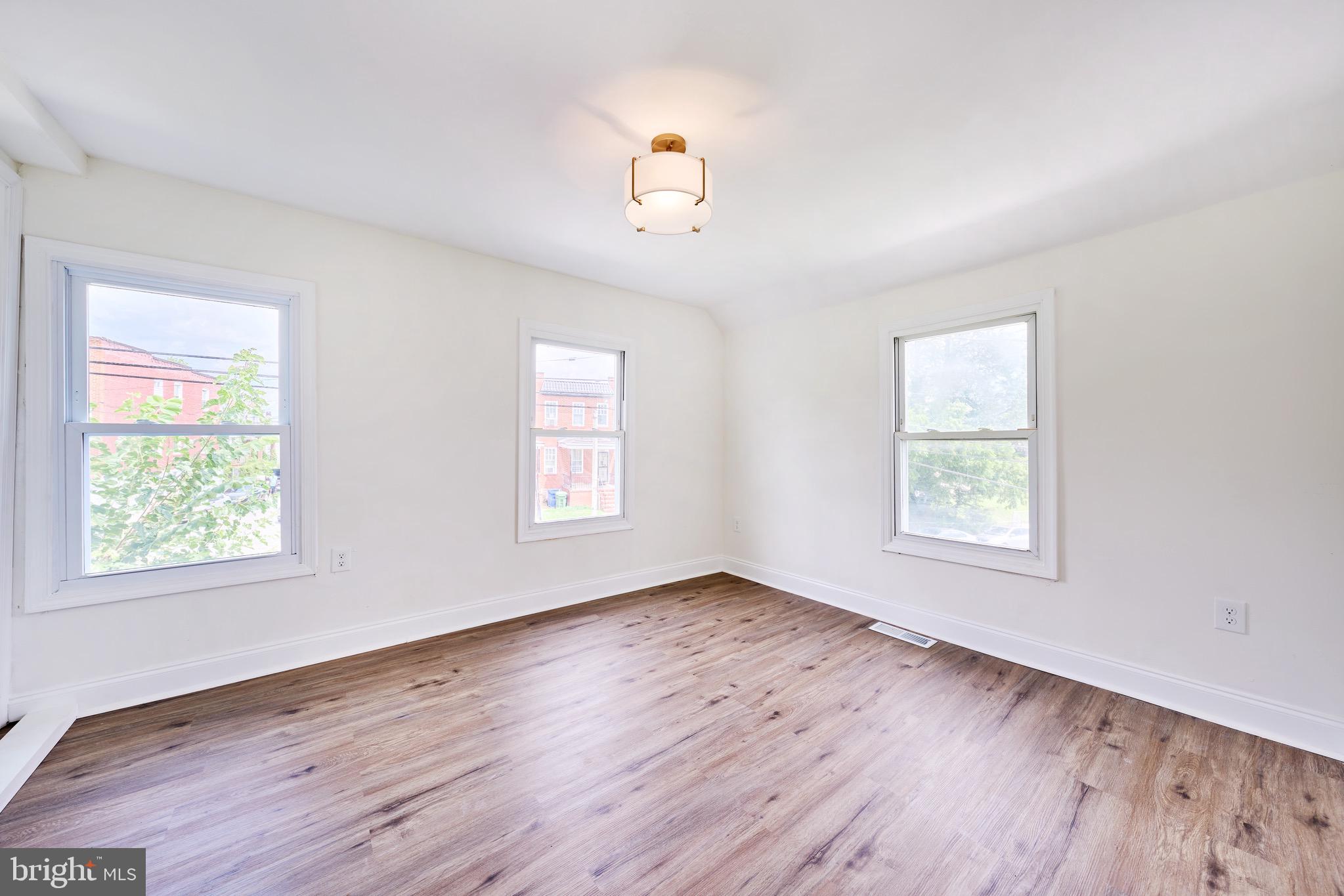 3511 Old Frederick Road Baltimore, MD 21229 - Photo 38 of 43 a view of an empty room with wooden floor and a window