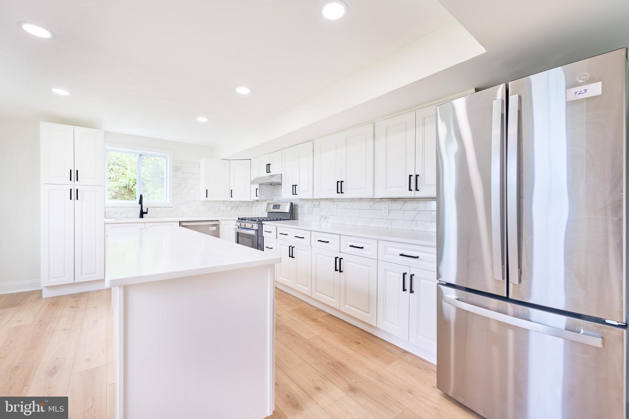 3511 Old Frederick Road Baltimore, MD 21229 - Photo 9 of 43 a kitchen with white cabinets and white stainless steel appliances