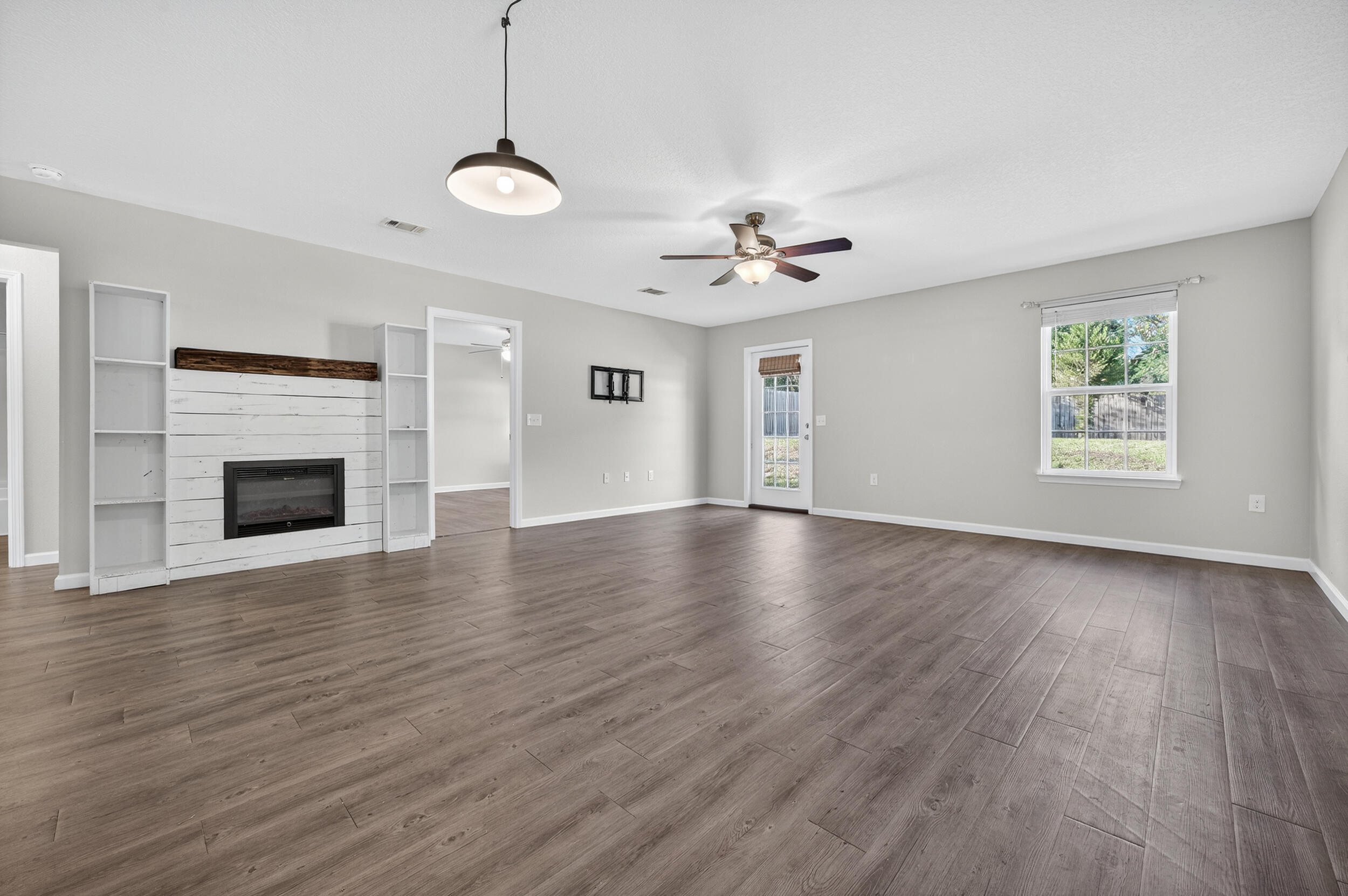 1833 Gainer Avenue Baker, FL 32531 - Photo 15 of 43 a view of an empty room with wooden floor and a window