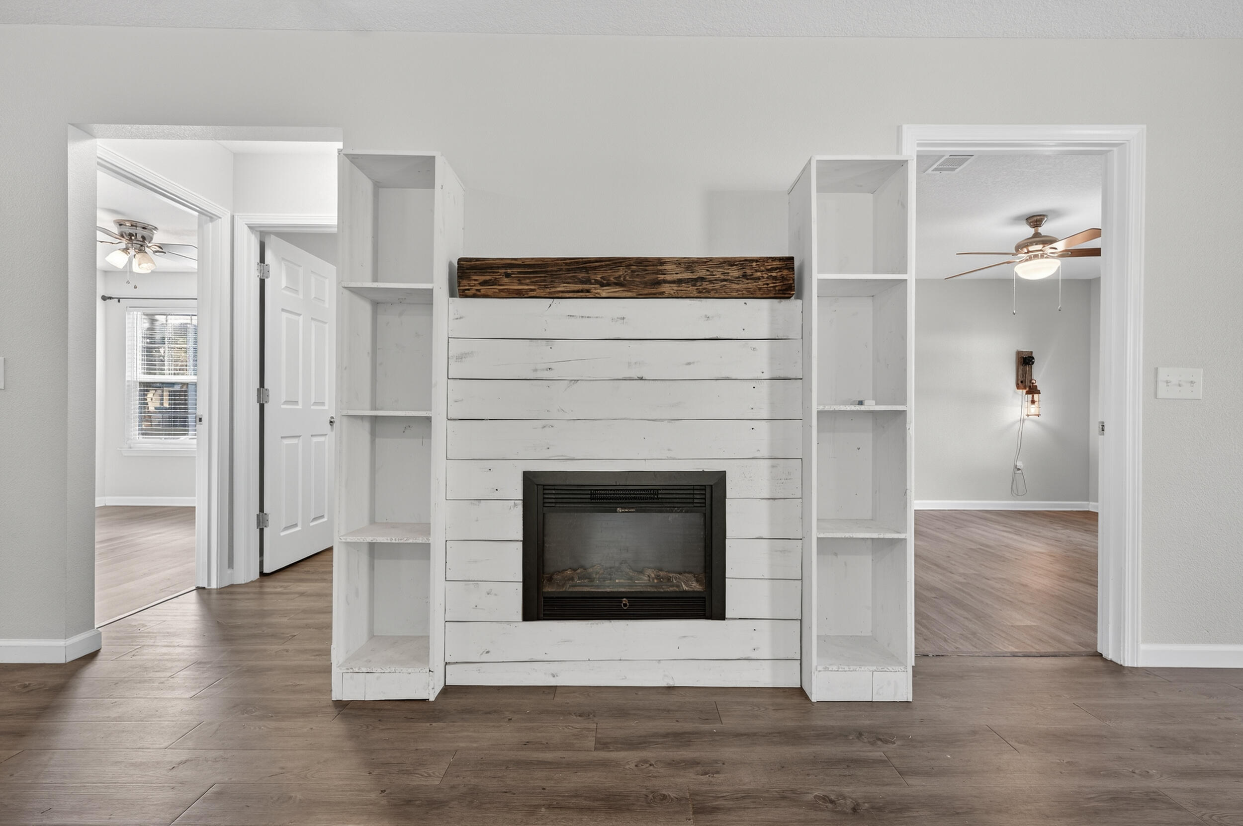 1833 Gainer Avenue Baker, FL 32531 - Photo 16 of 43 a living room with a fireplace and wooden floor