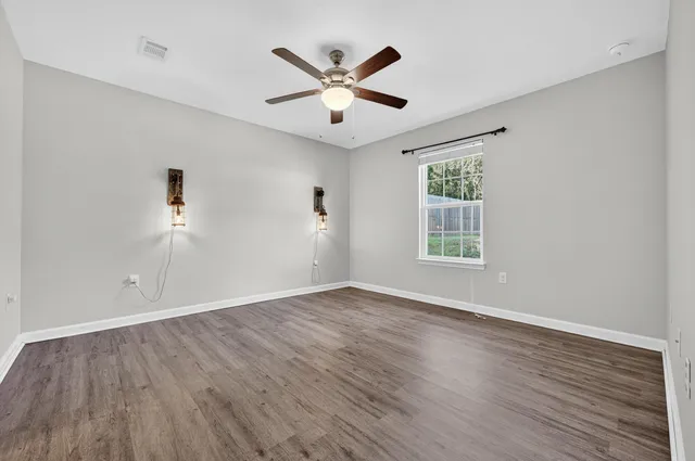 wooden floor in an empty room with a window
