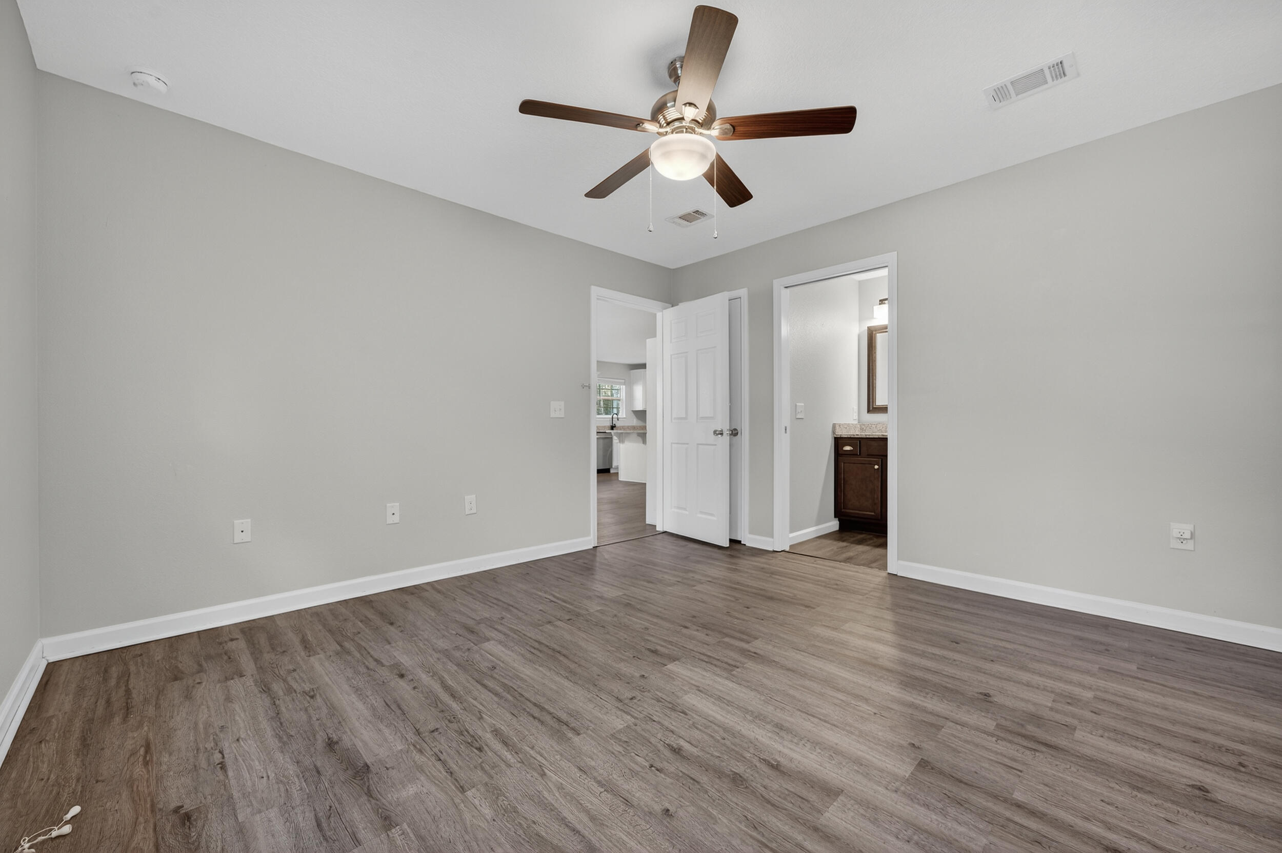 1833 Gainer Avenue Baker, FL 32531 - Photo 19 of 43 an empty room with wooden floor and ceiling fan