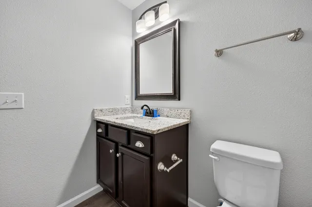 a bathroom with a sink a toilet and mirror